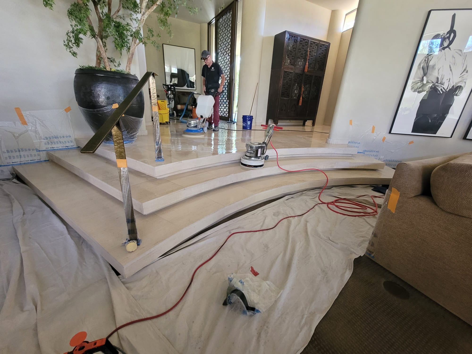 Stone restoration professional polishing an interior marble entry floor